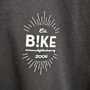 Black shirt. White ink. B!KE logo | Community Bike Shop.org | est. 2006
